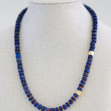 Necklace with blue beads on a mannequin against a white background