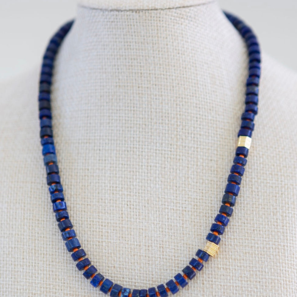 Necklace with blue beads on a mannequin against a white background