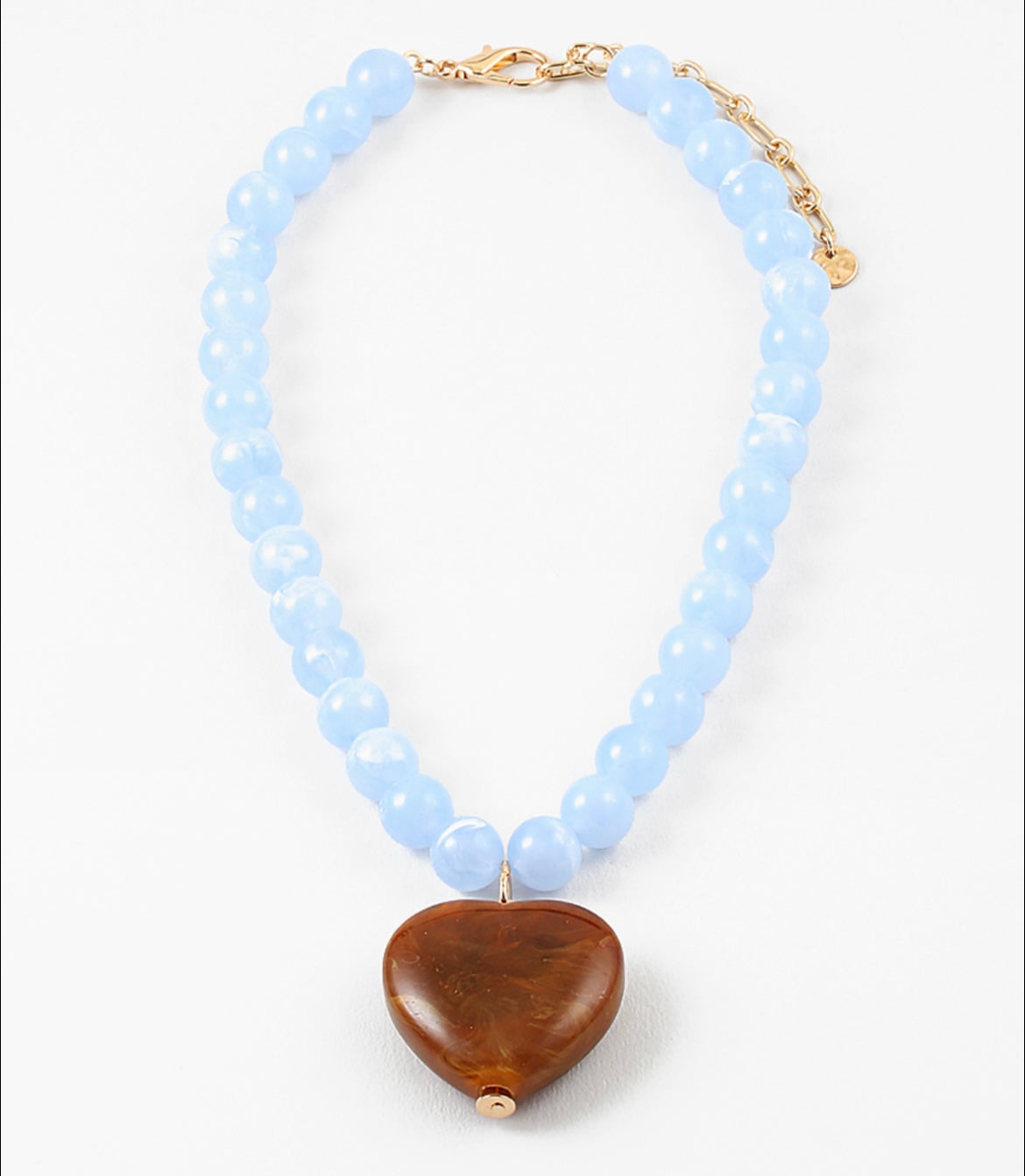 Necklace with light blue beads and a dark amber heart pendant on a white background