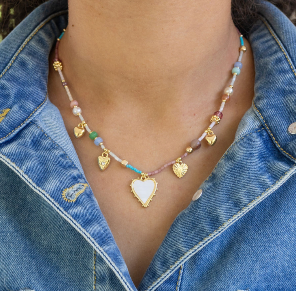 Bead necklace in blues, whites, beige and 4 gold heart pendants and white enamel heart pendant.