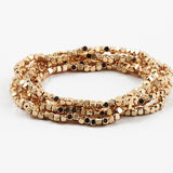 A set of gold-colored square stretch bracelets displayed against a white background.