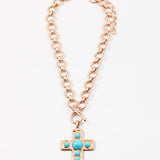Large circle link gold chain with a toggle clasp. Necklace has a gold Cross with turquoise beads set in it as a pendant.