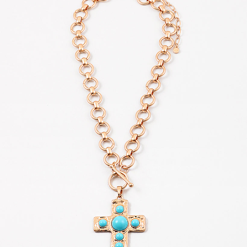 Large circle link gold chain with a toggle clasp. Necklace has a gold Cross with turquoise beads set in it as a pendant.