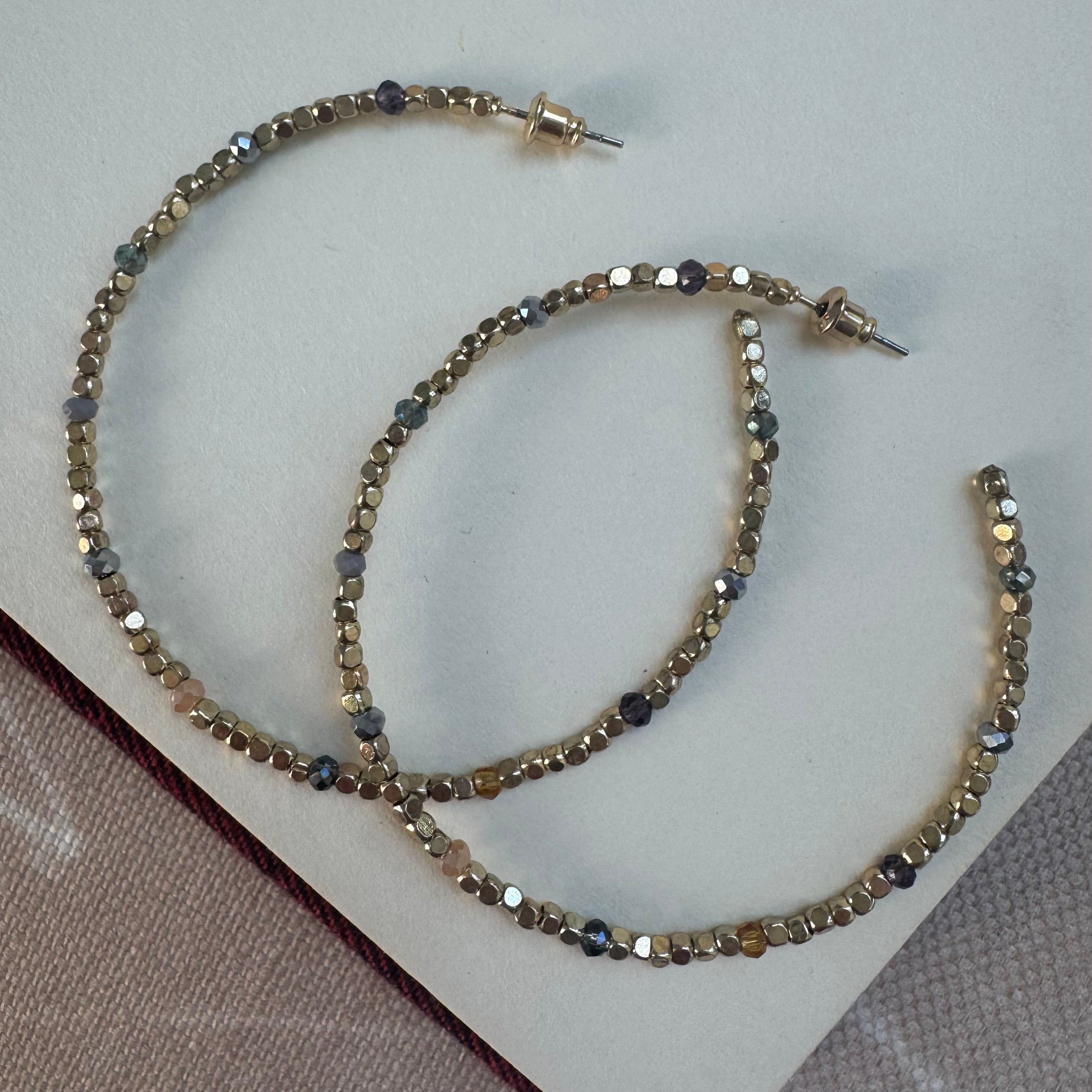 Large gold bead hoop earrings.