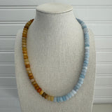 Picture of a bead necklace that is half amber yellow and half light blue.