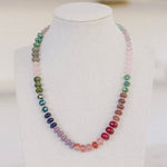 Green, blue, purple, red, brown and pink colored beaded necklace.