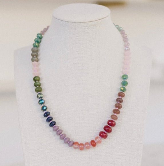 Green, blue, purple, red, brown and pink colored beaded necklace.