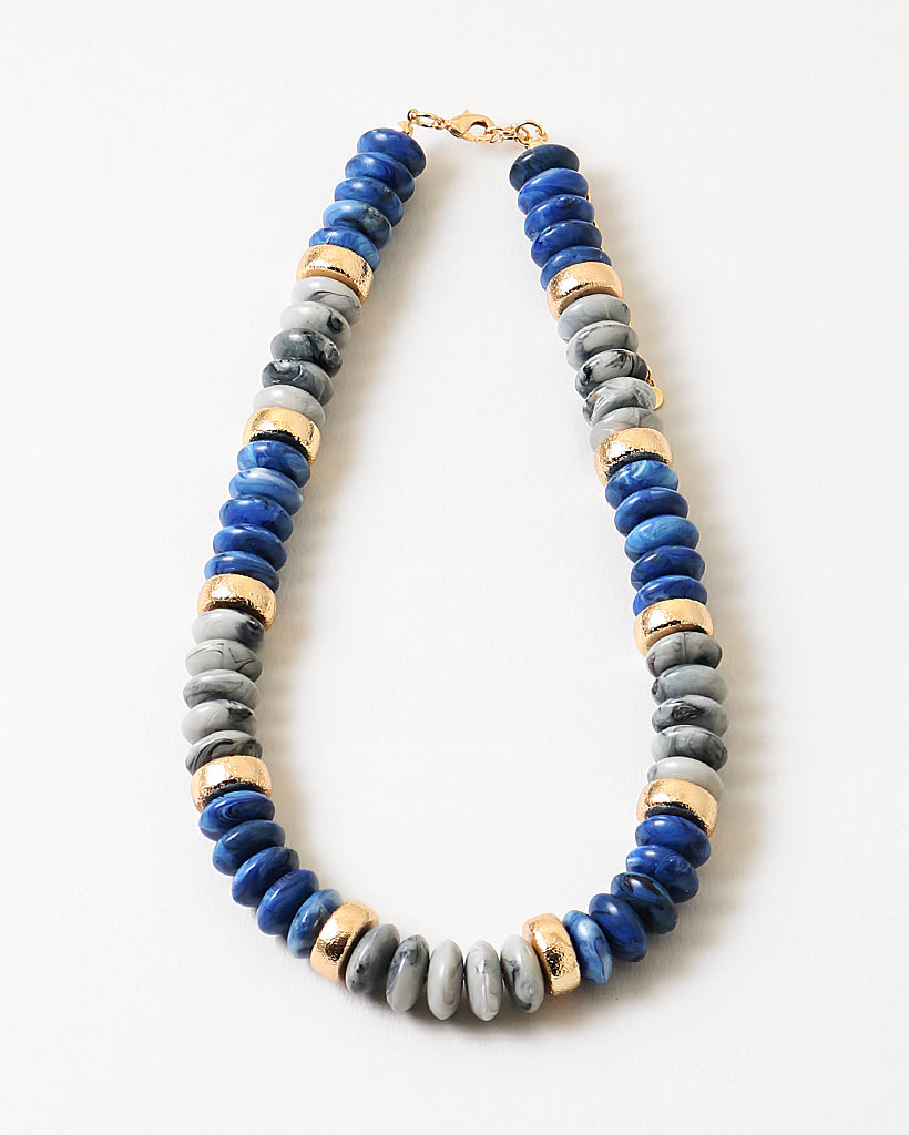 Chunky necklace with blue, gray and gold beads.