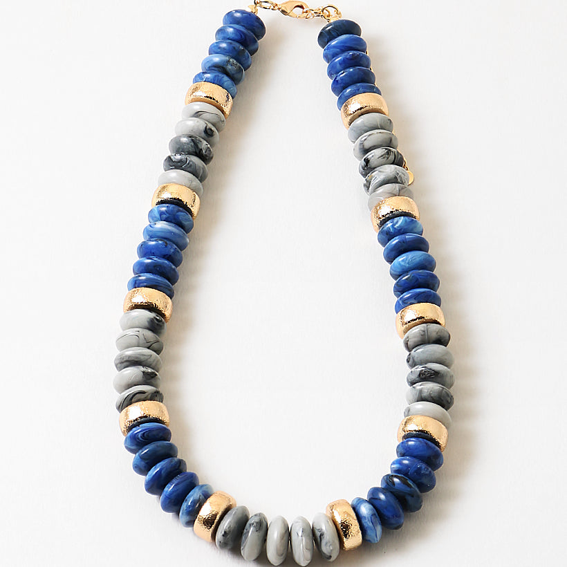 Chunky necklace with blue, gray and gold beads.