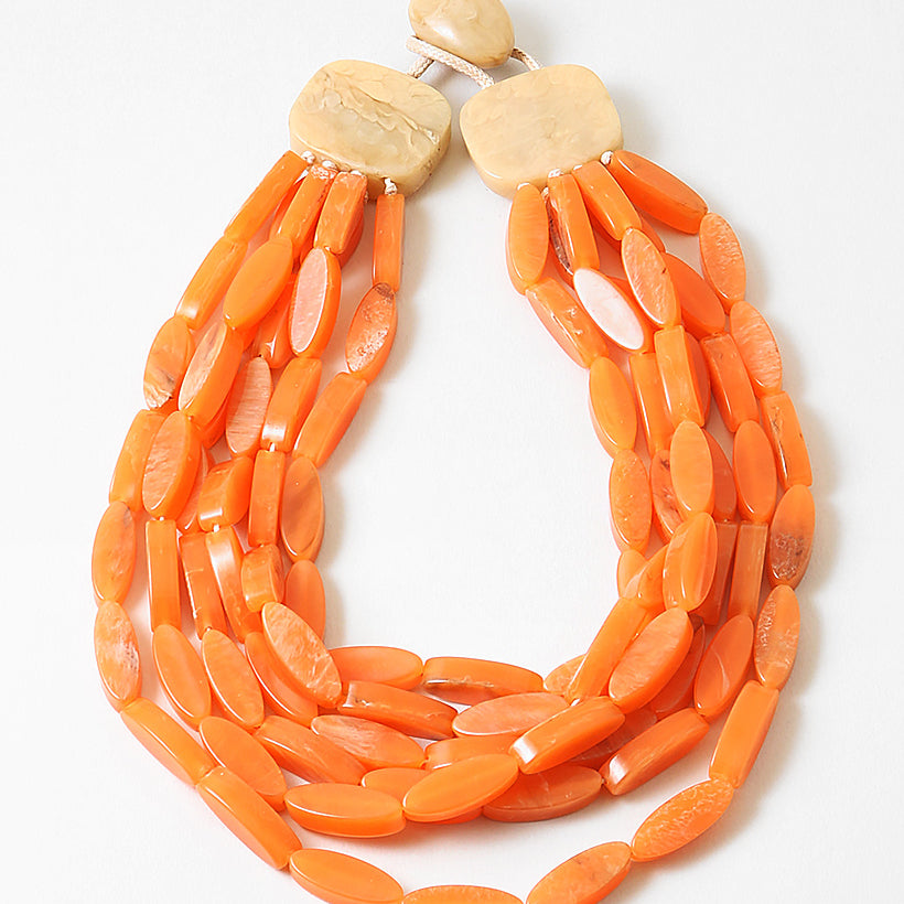 Picture of an orange flat oval bead bracelet made of 6 strands with a natural wood clasp.