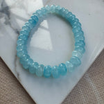 Blue beaded bracelet on a marble surface