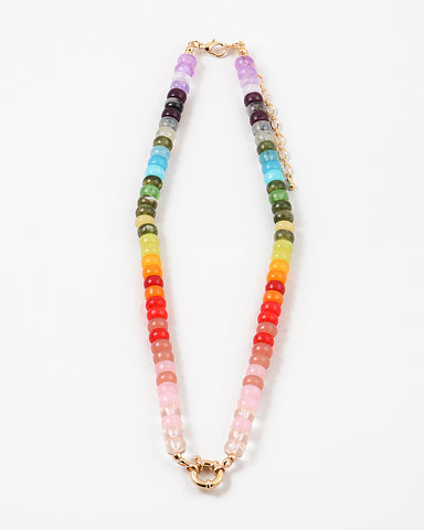 Picture of a bead necklace in purples, grays, greens, yellows, oranges, reds and pinks with a gold toggle clasp.