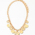 Picture of gold chain with nine hammered gold disc pendants.