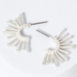 Set of silver starburst hoop earrings.