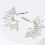 Set of silver starburst hoop earrings.