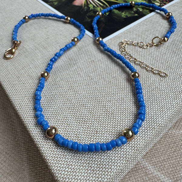 Picture of a dark blue seed bead necklace with accent gold beads 