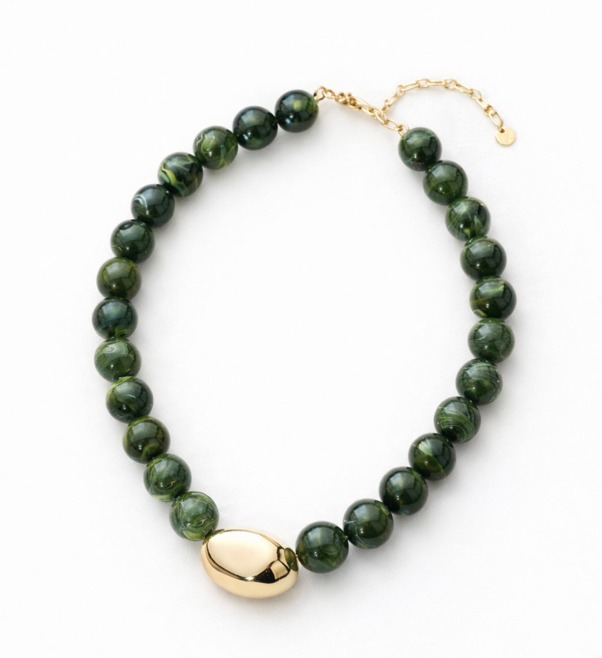 Green beaded necklace with a large central gold bead with a gold clasp on a white background.
