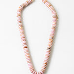 Necklace with pink beads on a white background