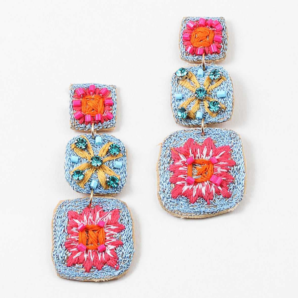 Woven dangle earrings in blues, reds and yellows.