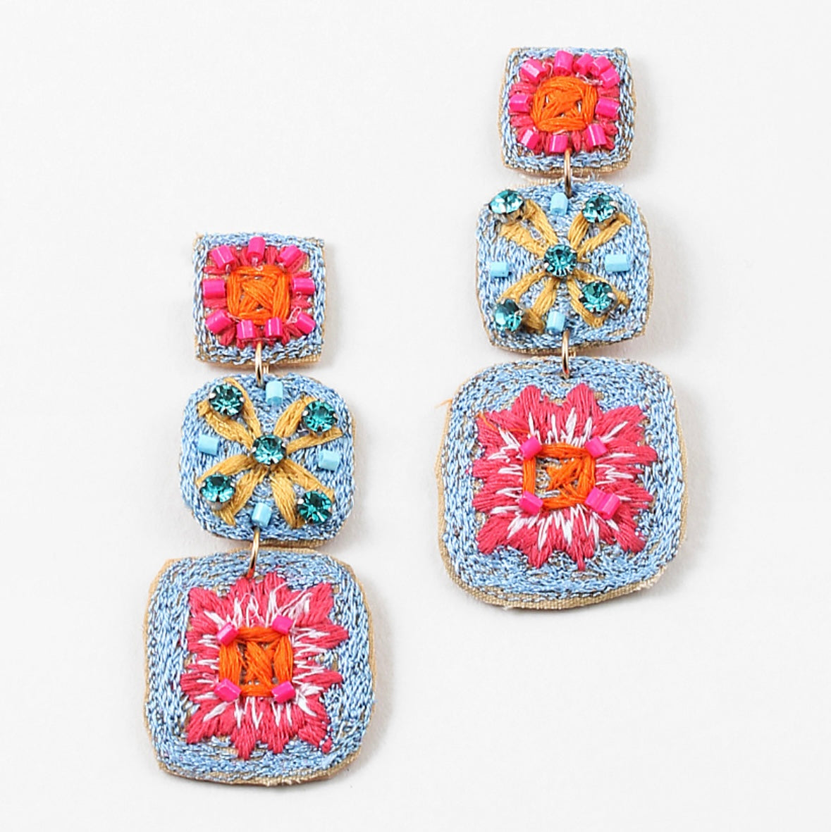 Woven dangle earrings in blues, reds and yellows.