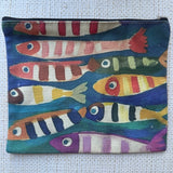 Small pouch with colorful fish pattern on a textured fabric background