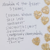Picture of words and 8 textured heart pendants.  Words read: Meaning of the Heart Symbol: Central Wisdom, Self Love, Movement, Sincerity & Clarity, Friendship, Compassion & Understanding, Affection, Truth.