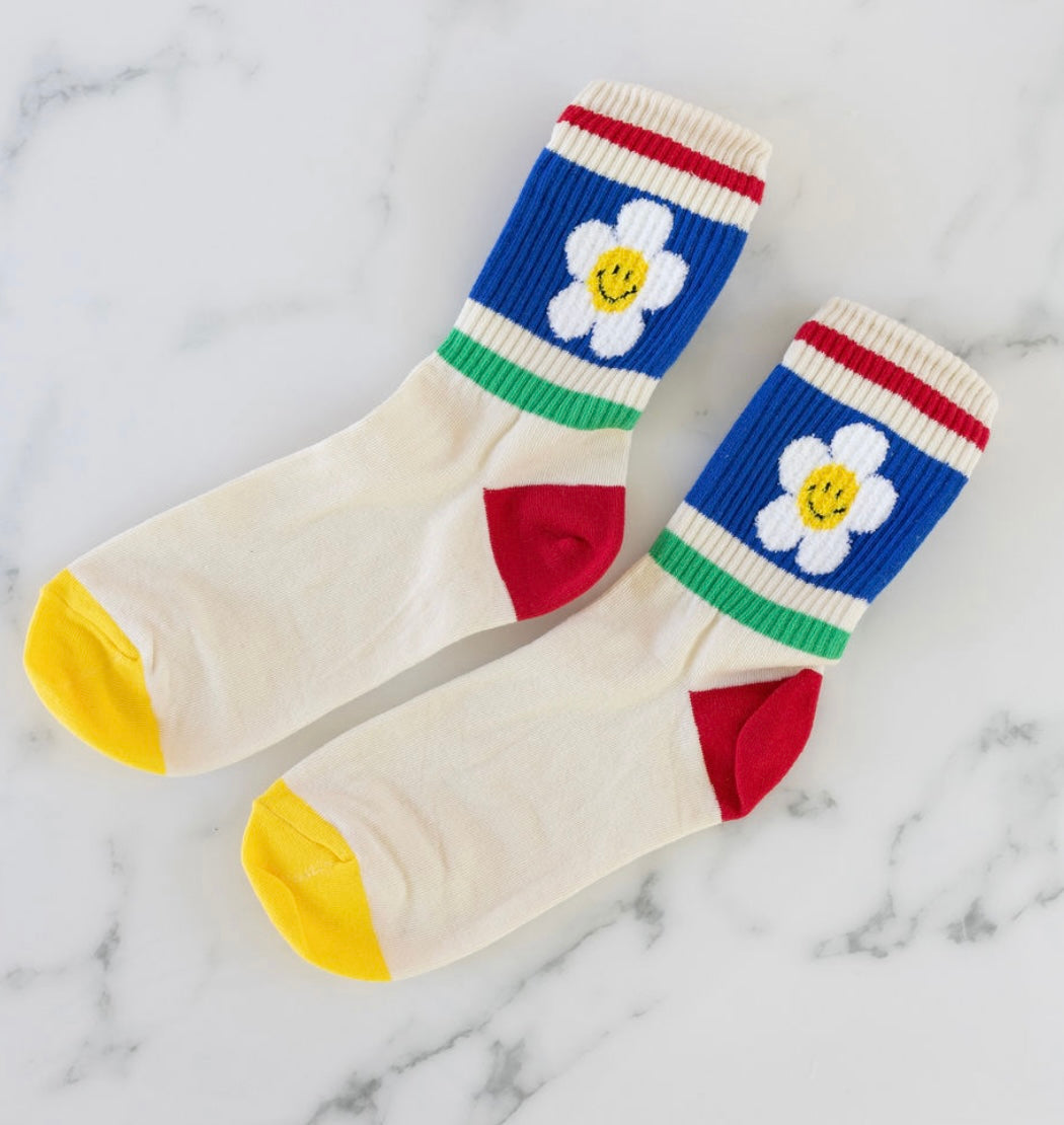 Colorful socks with retro flower primary color block design on a marble background