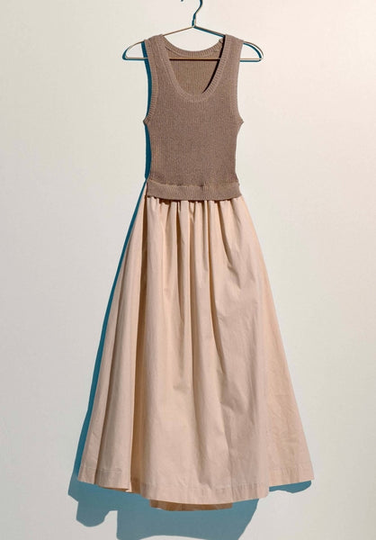 Two-tone sleeveless dress with brown top and beige skirt on a hanger against a white background