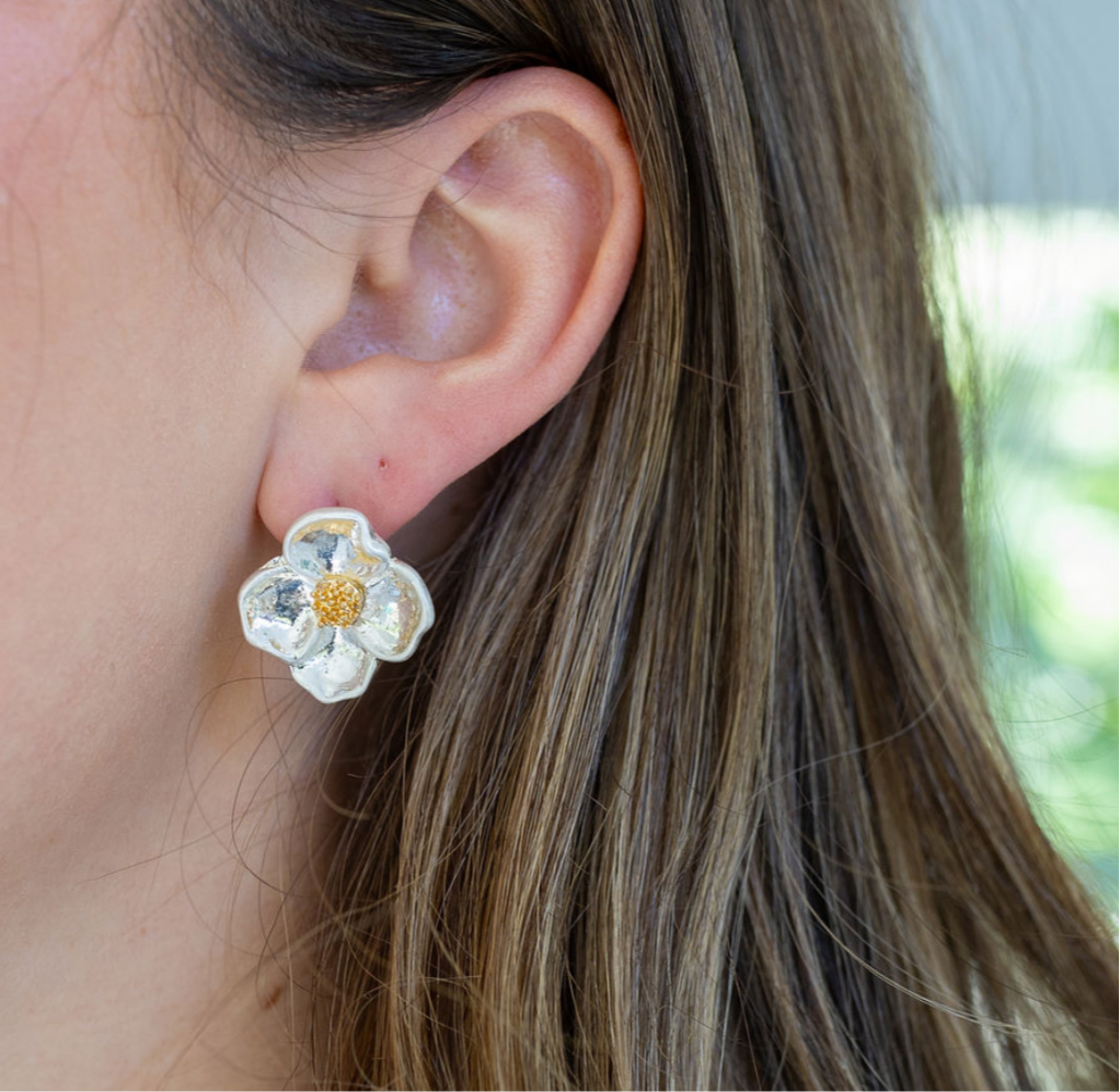 Large stud earring that looks like a white dogwood flower.