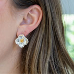 Large stud earring that looks like a white dogwood flower.