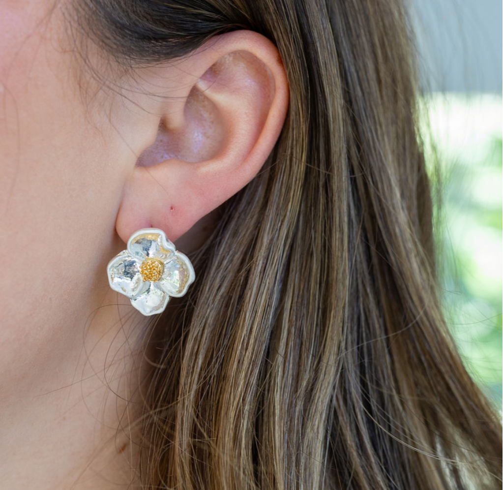 Large stud earring that looks like a white dogwood flower.