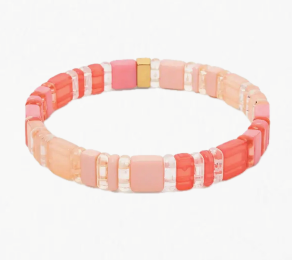 Picture of bracelet made of clear and solid rectangle beads in shades of coral.