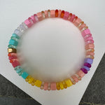 Picture of a multicolored bead bracelet. Beads are mostly in pinks, yellows, turquoise and purple.