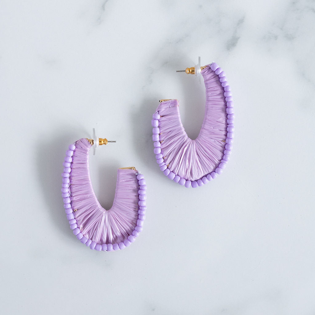 Picture of U- shaped hoops covered by lavender thread and lavender colored beads.