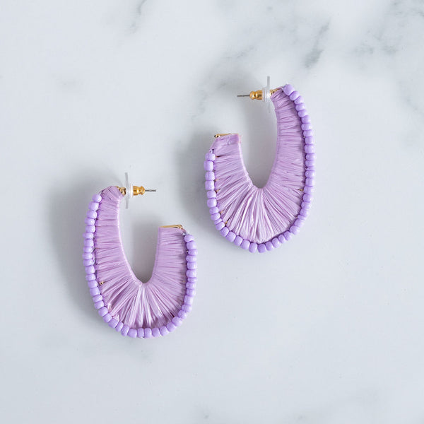 Picture of U- shaped hoops covered by lavender thread and lavender colored beads.