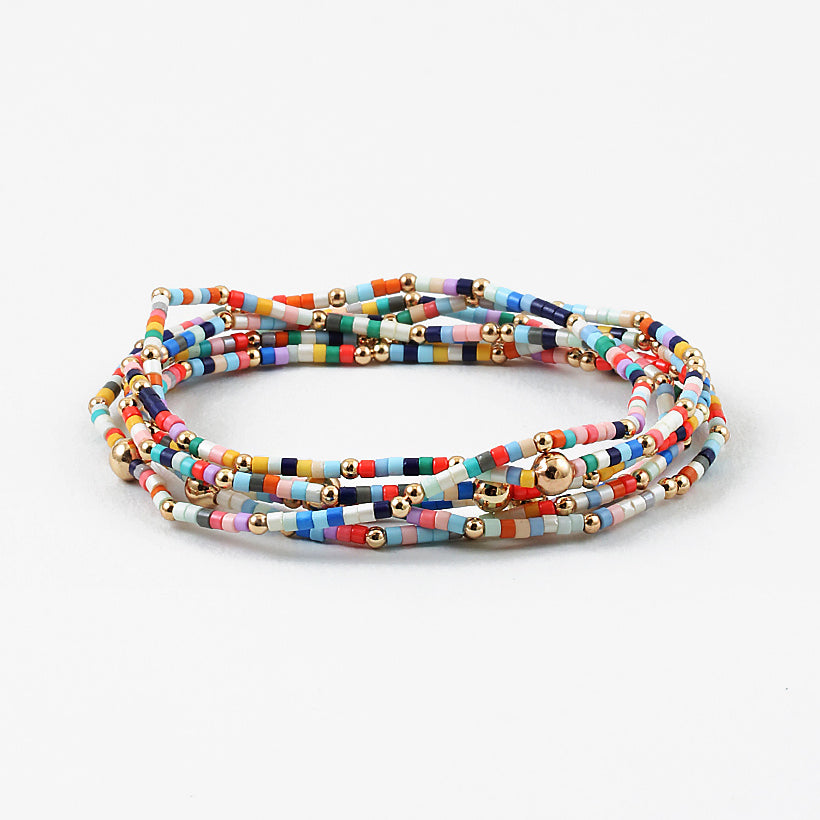 Picture of layered multicolored seed beaded bracelet with gold spacer beads.