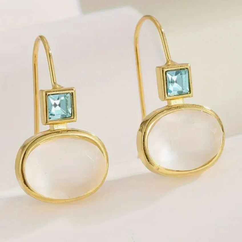 Picture of opaque oval beads topped with clear blue square diamonds.