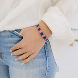 Picture of a woman's wrist displaying a bracelet in blue and pink beads.