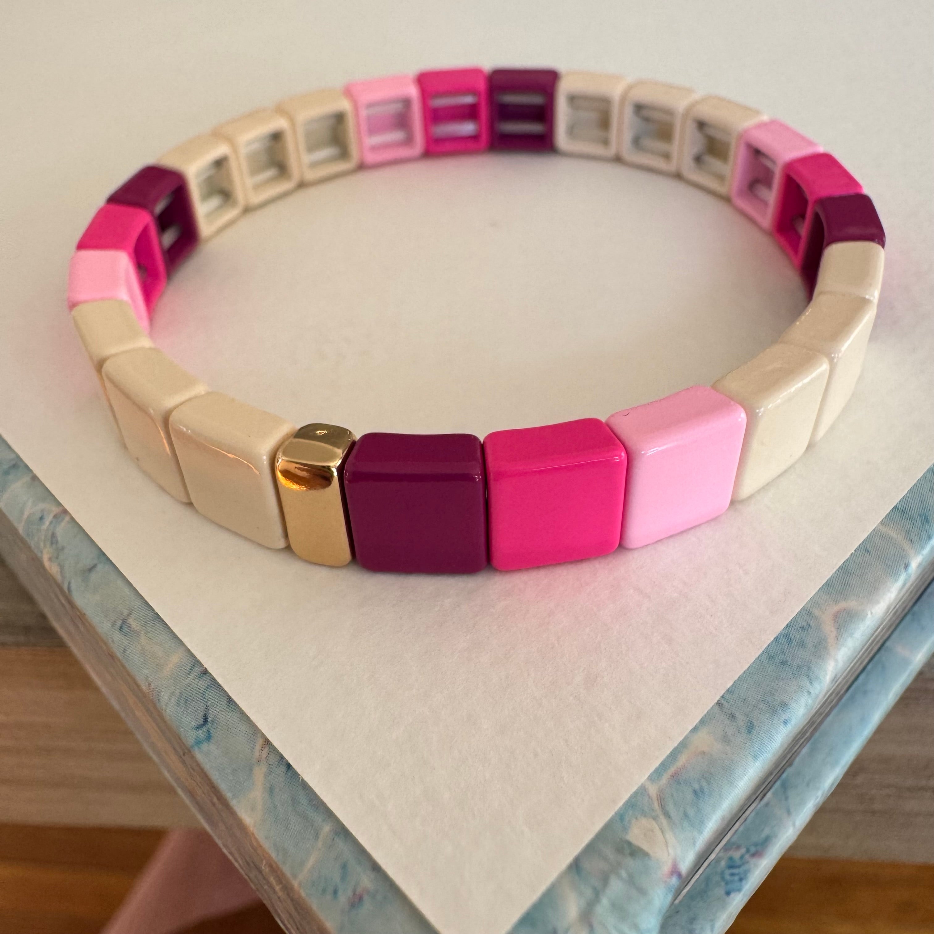 Square bead bracelet in ombre pinks and beige.