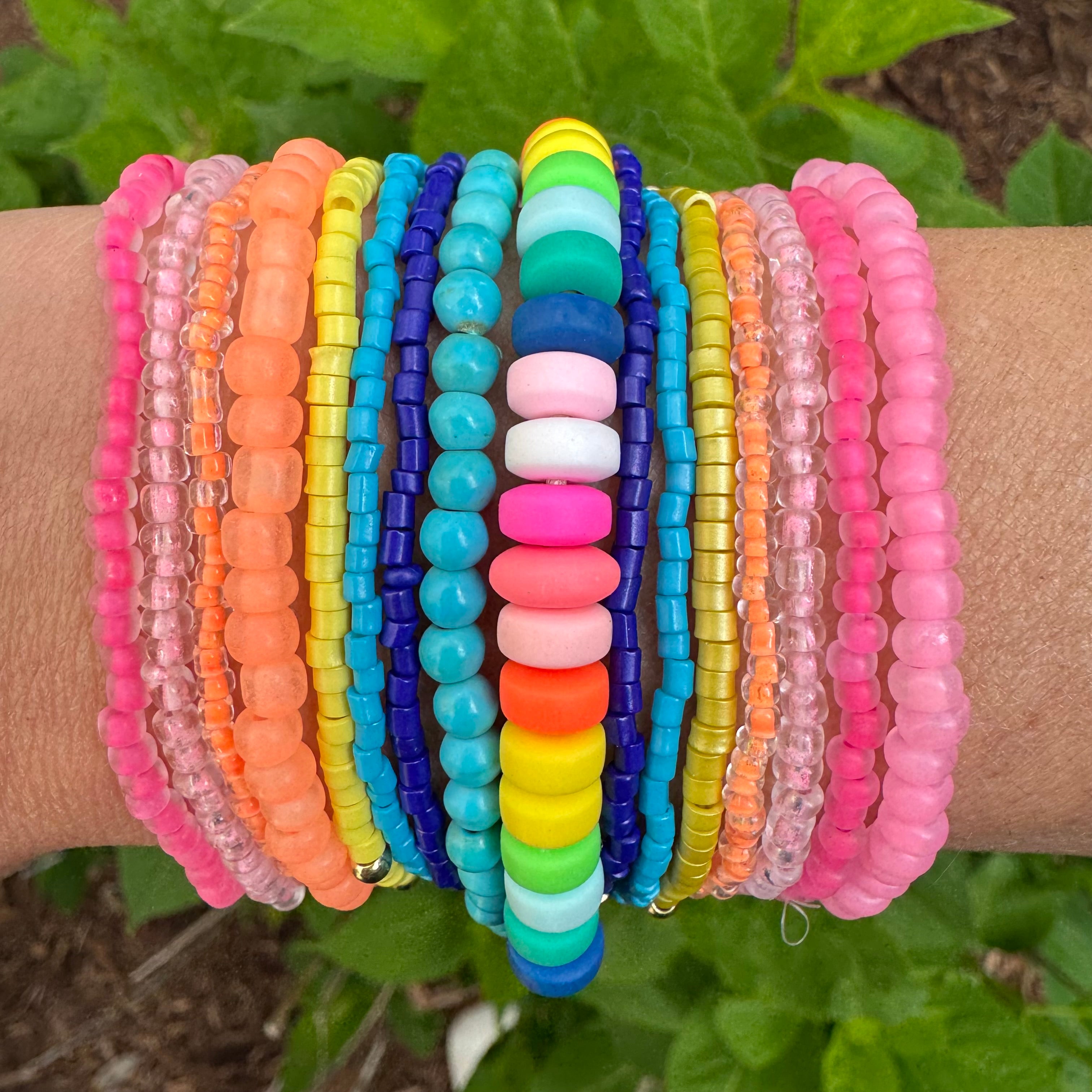Beautiful set of 16 beaded bracelets. Bracelets are pink, orange, blue, turquoise, yellow and multicolored.