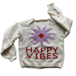 Picture of a cream colored sweater with a purple flower with a red center and red lettering that read, "Happy Vibes".