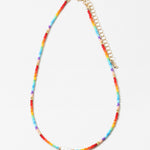 Necklace with colorful rainbow beads and a gold chain on a white background