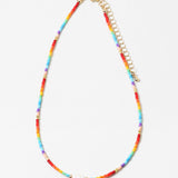 Necklace with colorful rainbow beads and a gold chain on a white background