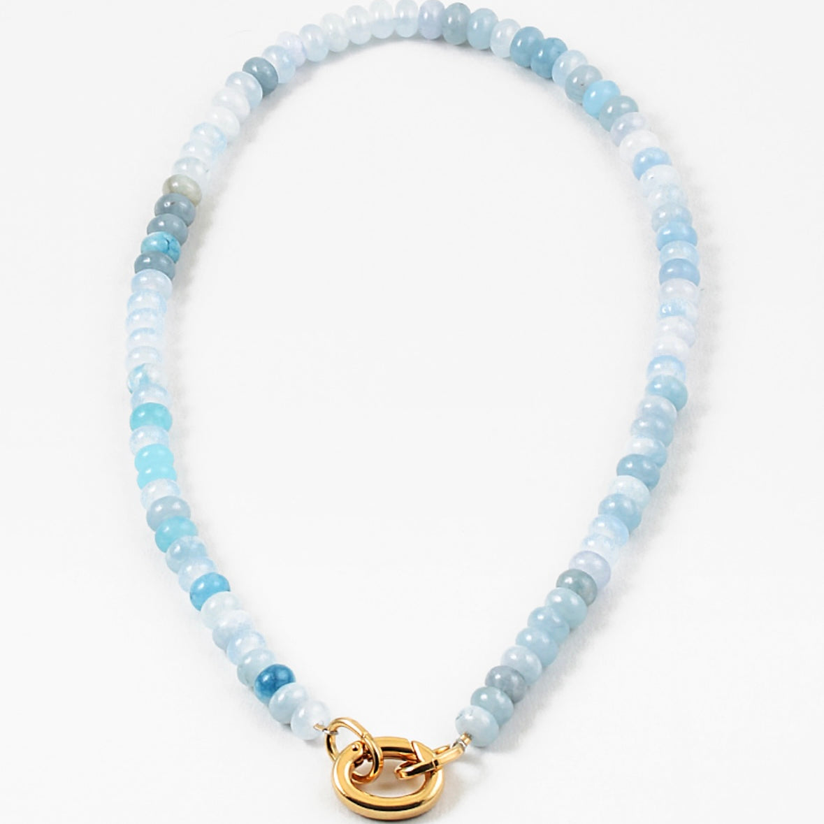 Light blue bead necklace in varying shades of blue with a large gold carabiner clasp.