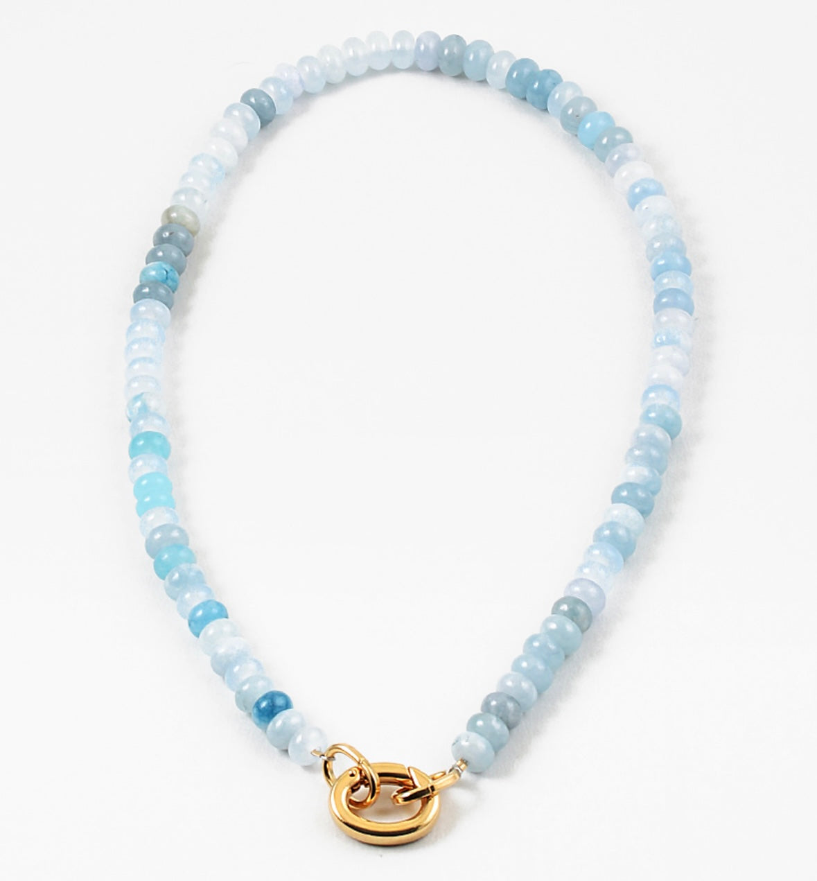Light blue bead necklace in varying shades of blue with a large gold carabiner clasp.