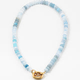 Light blue bead necklace in varying shades of blue with a large gold carabiner clasp.