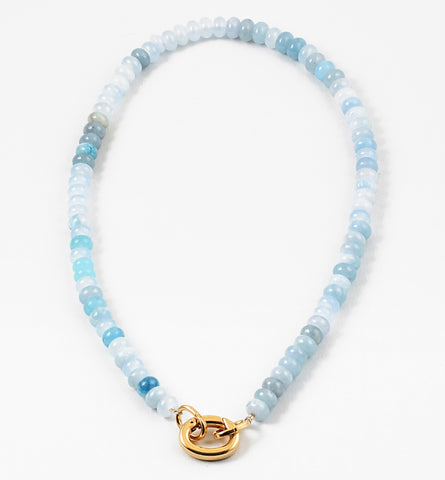 Light blue bead necklace in varying shades of blue with a large gold carabiner clasp.
