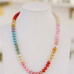 Multicolored necklace in red, orange, purple, blue, creams and pinks.