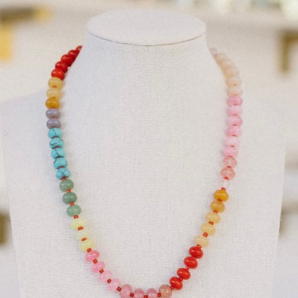 Multicolored necklace in red, orange, purple, blue, creams and pinks.