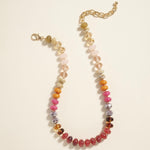 Bead necklace in rust oranges, pinks and clear colors